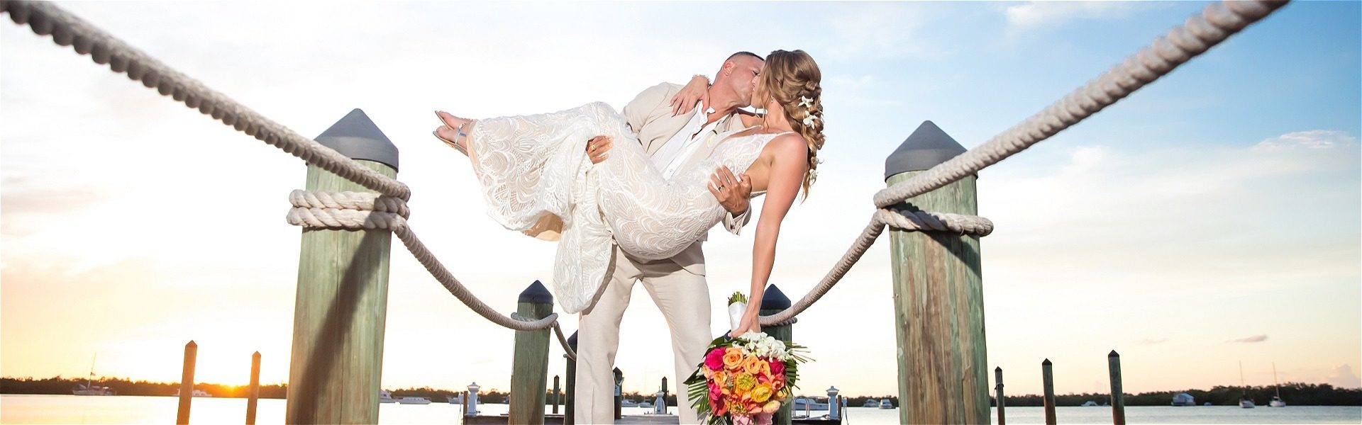Bride swept off her feet on the dock of the coconut palm inn